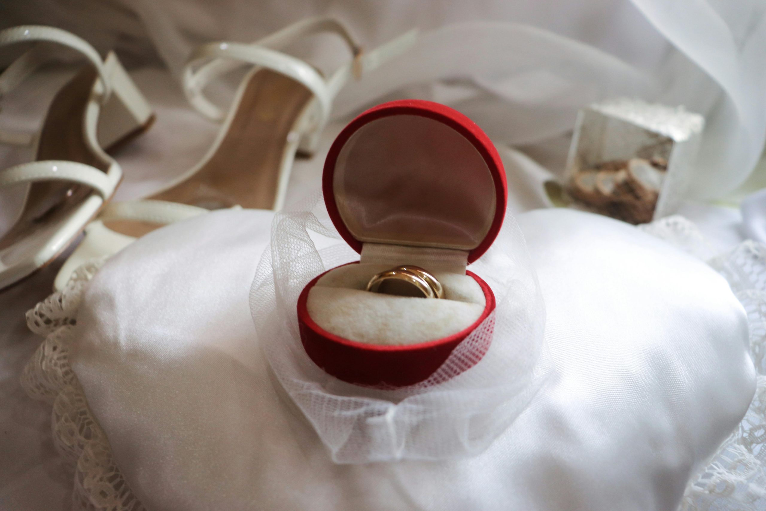 Gold wedding band on white textile